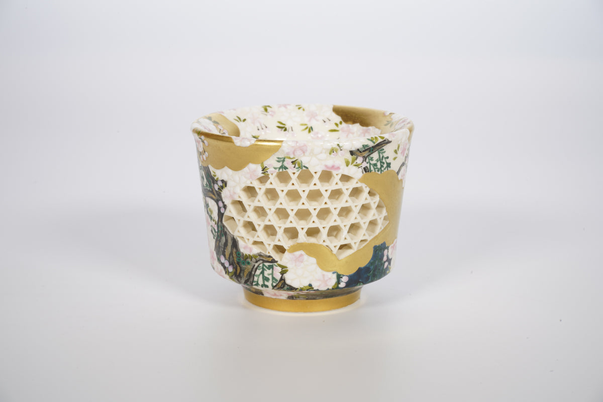Sake cup with a cherry blossom design by Kyuzo .